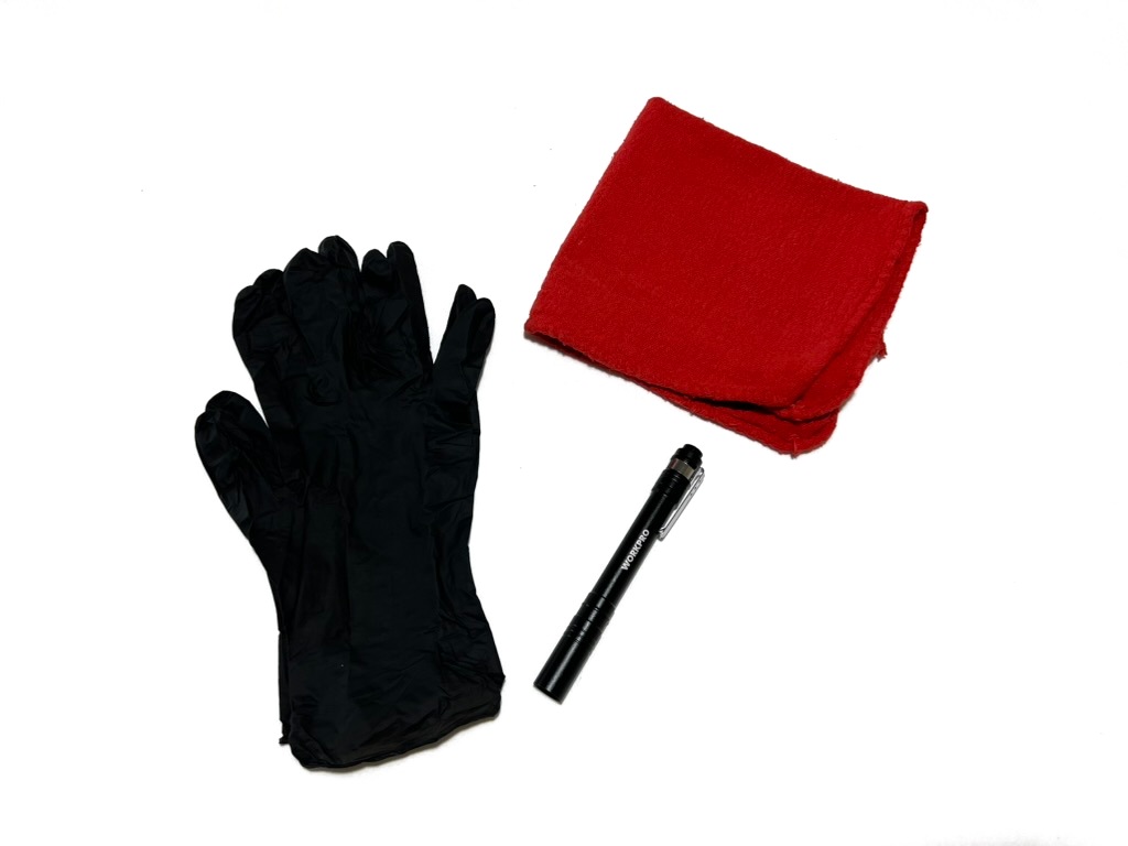 The under-the-hood kit: black nitrile gloves, a red shop rag and a pen flashlight